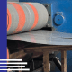 A metal slitting machine cutting wide coils into precise strips at East Lake Metals.