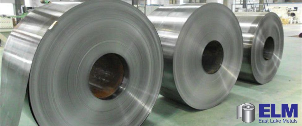 Industrial mill-finish aluminum master coils lined up on a factory processing floor, demonstrating core manufacturing advantages of building with aluminum with East Lake Metals.