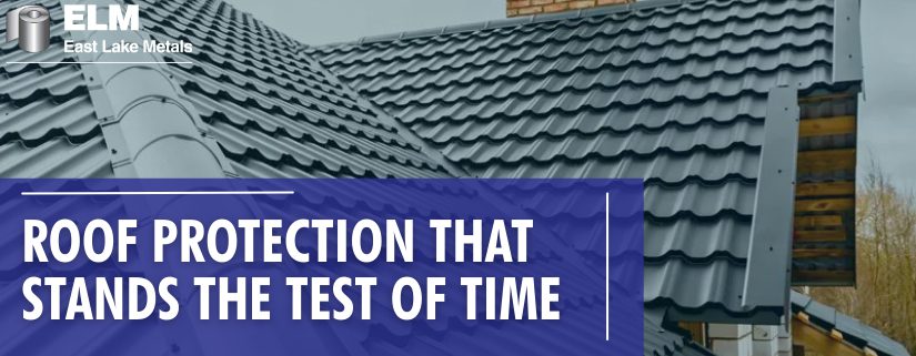 A close-up of a dark grey metal tile roof with a prominent ridge cap and protective finishes designed for preventing chalking and fading in metal roofing.