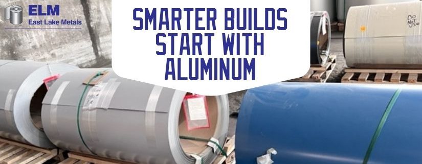 Heavy-duty structural metal master coils staged on wooden pallets in a distributor warehouse, illustrating the material advantages of building with aluminum from East Lake Metals.