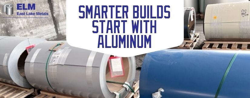 Heavy-duty structural metal master coils staged on wooden pallets in a distributor warehouse, illustrating the material advantages of building with aluminum from East Lake Metals.
